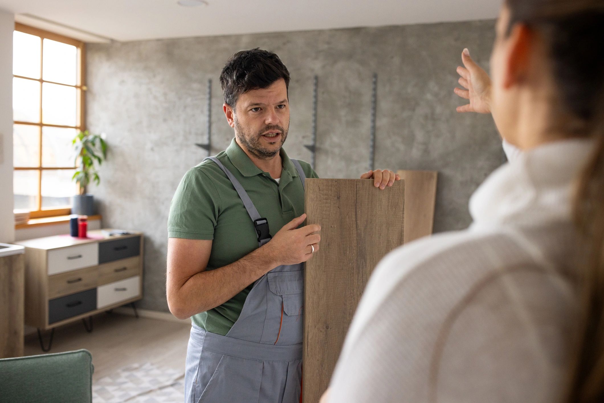 Technician discussing maintenance needs with a customer in an apartment