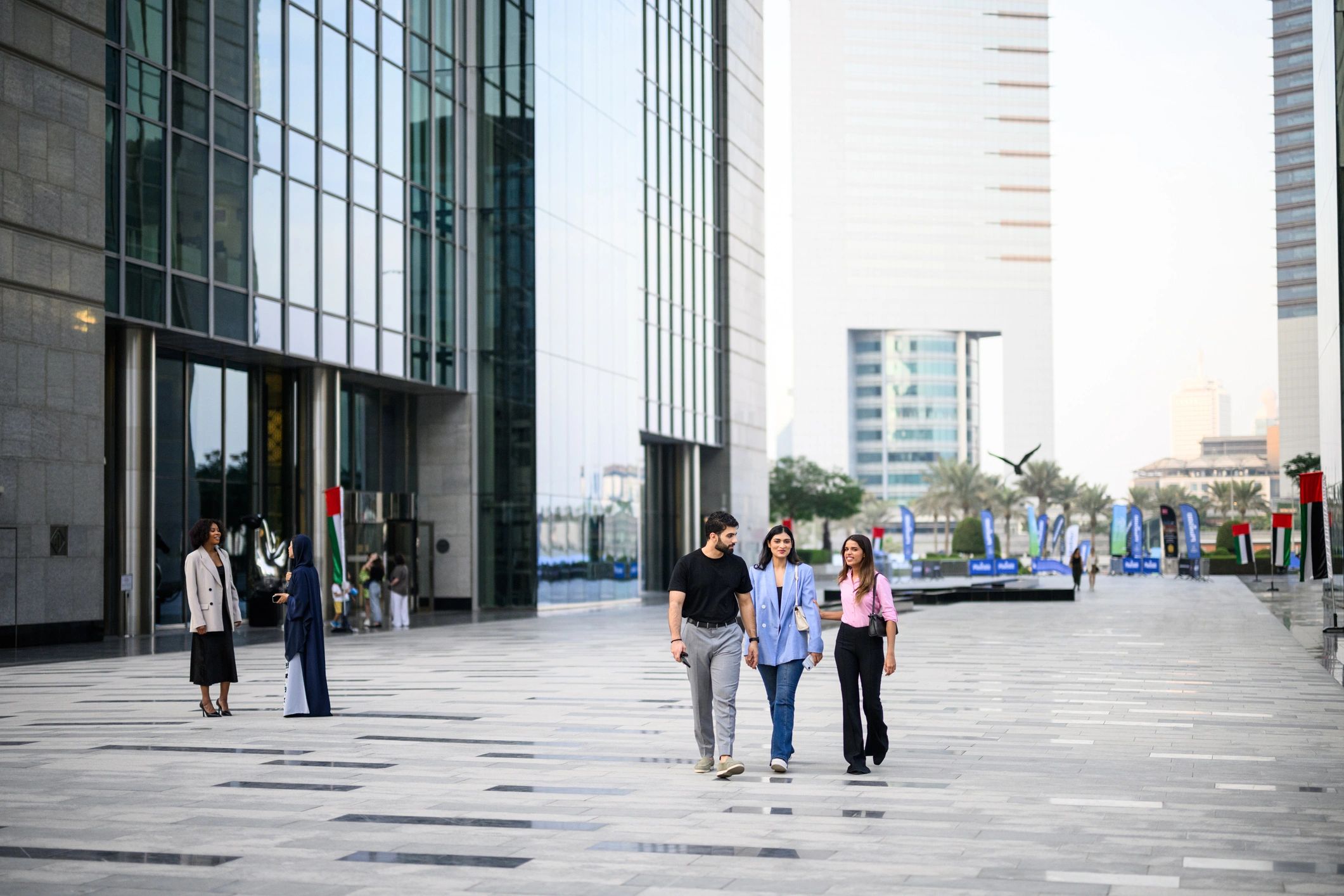 Professionals walking near modern buildings in Dubai